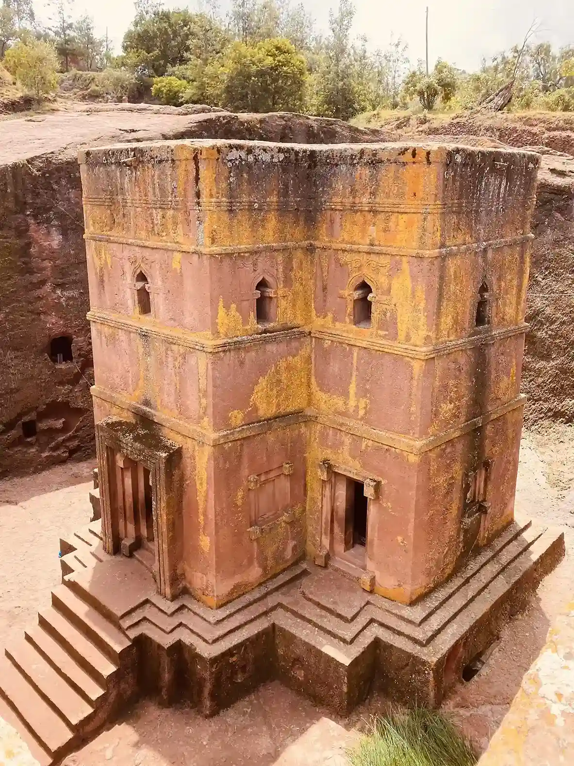 Elevated view of a monolithic rock-hewn church carved into the ground in Lalibela, Ethiopia