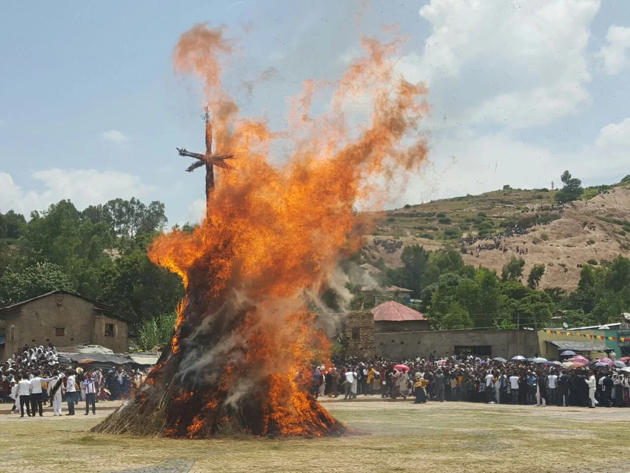 The Meskel Demera bonfire burning with a hillside crowd gathered in the background, Ethiopia