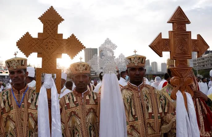 Ethiopian Orthodox worshippers carrying carved wooden crosses during the Meskel festival