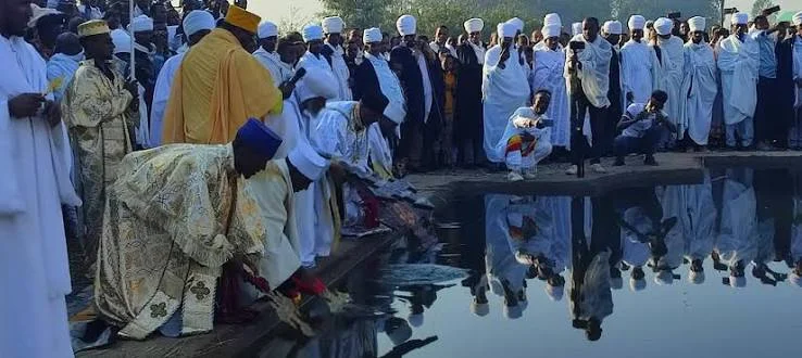 Ethiopian Orthodox priests blessing the water at dawn during the Timkat Epiphany ceremony